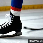 스케이트 착용법 - A detailed close-up of a person trying on ice hockey skates indoors, wearing thick wool socks, fully...